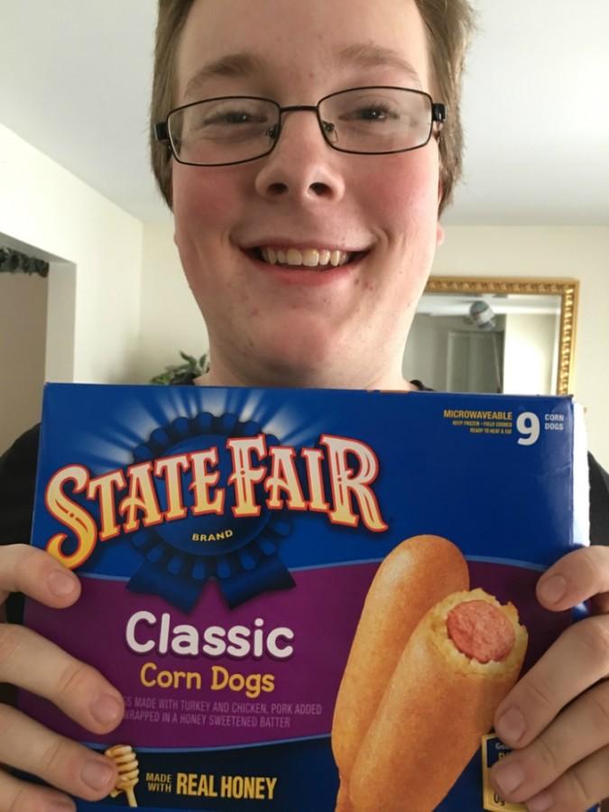 Senior Jacob DePottey poses with a box of corn dogs. DePottey snacked throughout the snow day. 