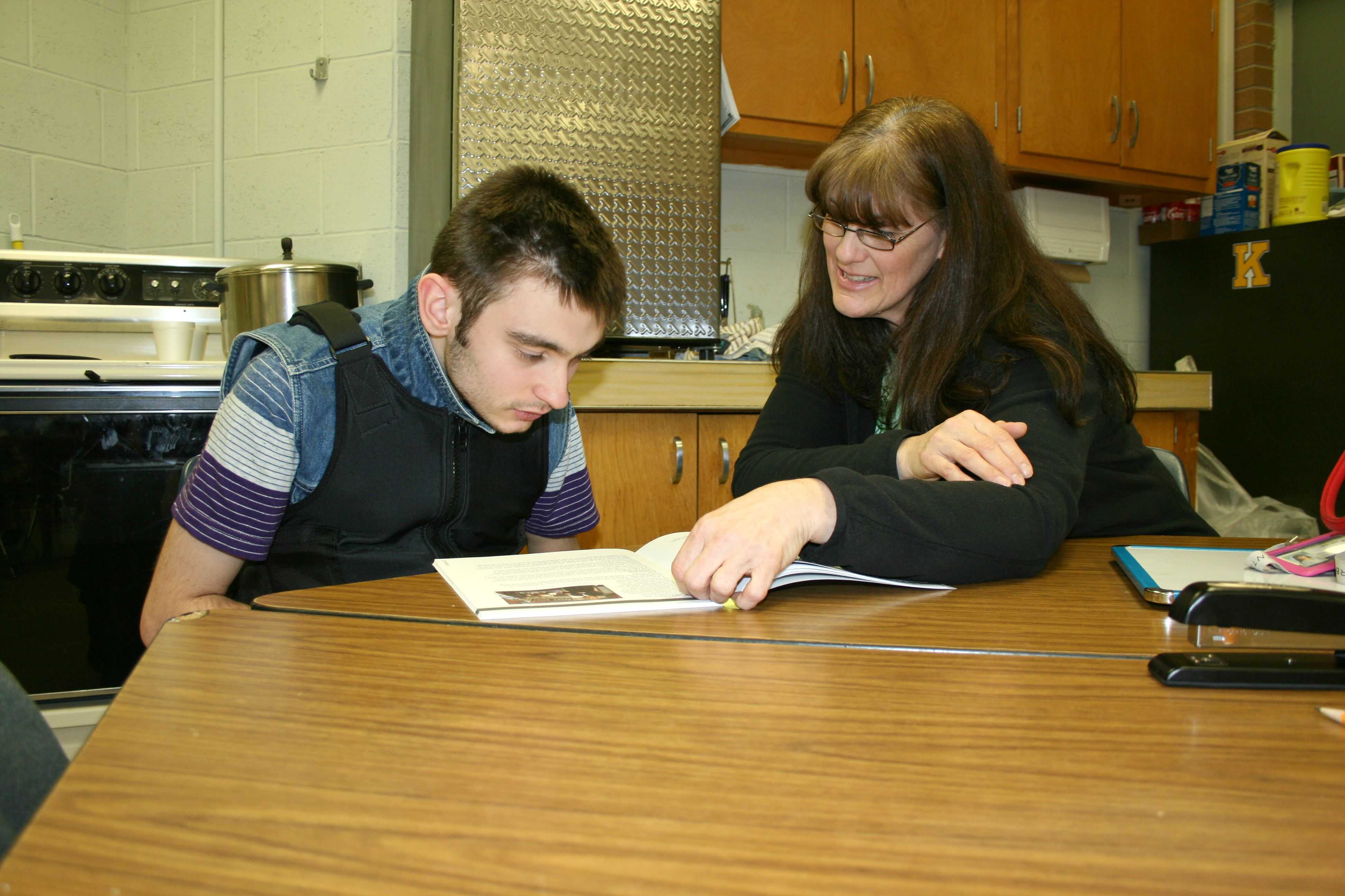 Junior Alex Molter (left) reads with Miss Annette Orth on Wednesday, March 23.