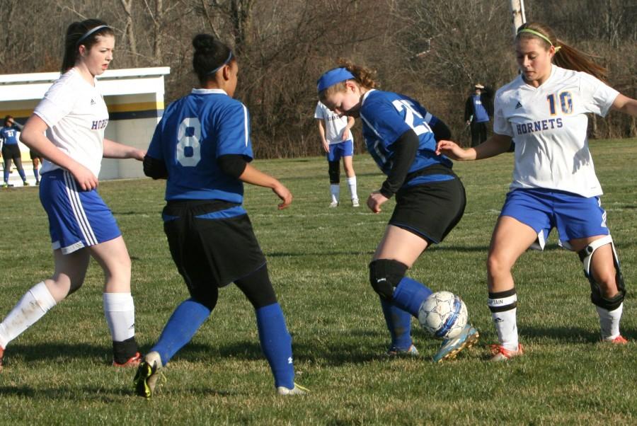 Alexis Allen, junior, attempts to control the ball against Carman-Ainsworth on Tuesday, March 29.