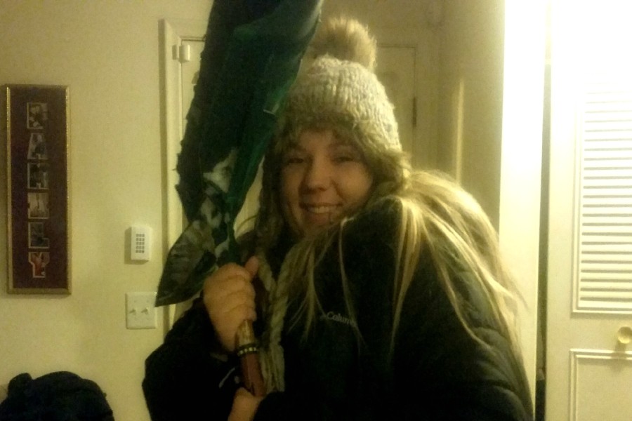 Senior Makenzie Schroeder poses with a shovel before going outside to clear her driveway on Thursday, March 2.