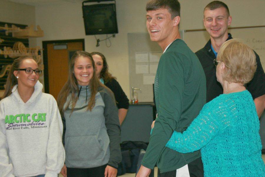 Ms. Dorie Mather (right), school nurse, demonstrates the Heimlich maneuver on senior Liam Grathoff  Thursday, April 28. The Human Anatomy and Physiology class was certified in CPR and other first aid training.
