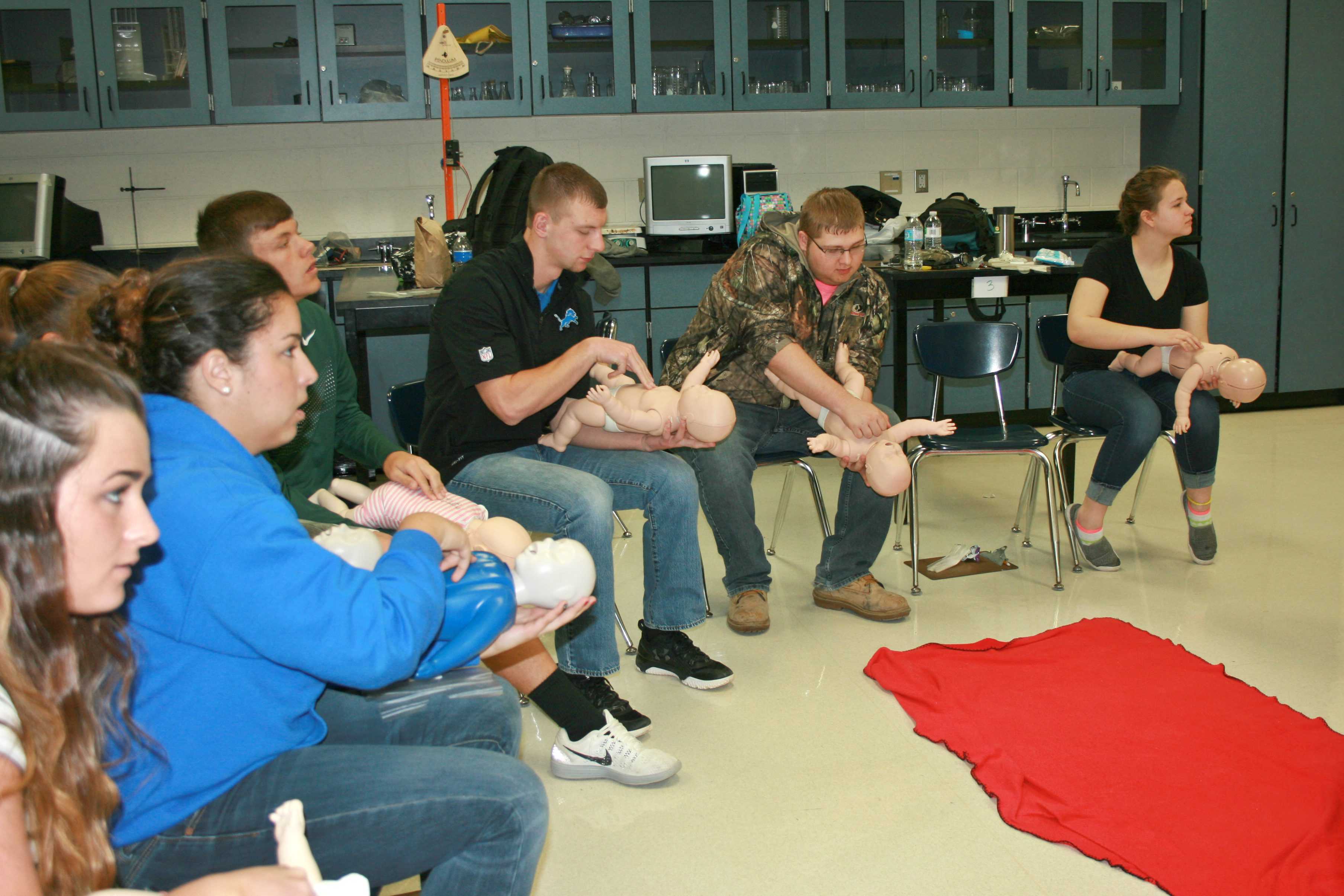 Mrs. Kandy Cousins' HAP class learns to perform CPR on infants.