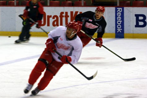 Players rush for the puck.
