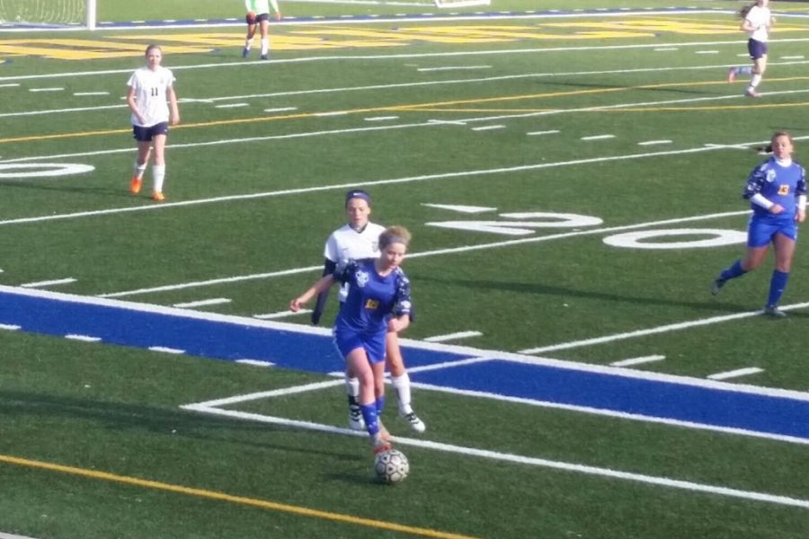 Junior Alexis Kelly chases after the ball.