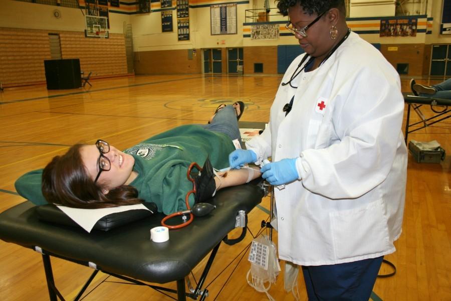 Mrs. Jereatha Flannery (right) draws blood from sophomore Hannah Alexander.