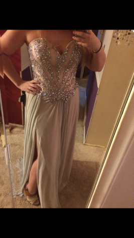 Senior Mikayla Stevens models her prom dress in front of her mirror.