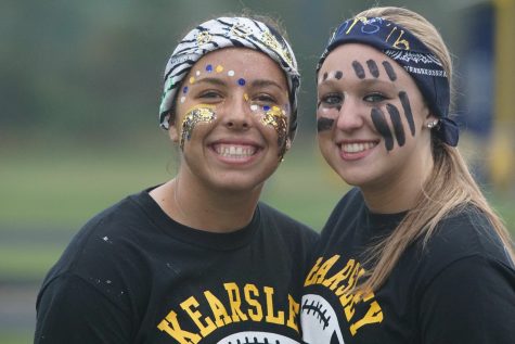 Seniors Bri Finley and Brooke Crow paint their faces and play in the powder puff game.