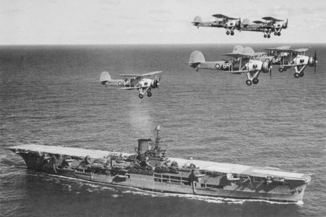 British aircraft carrier Ark Royal with a flight of "Swordfish" overhead, circa 1939. 