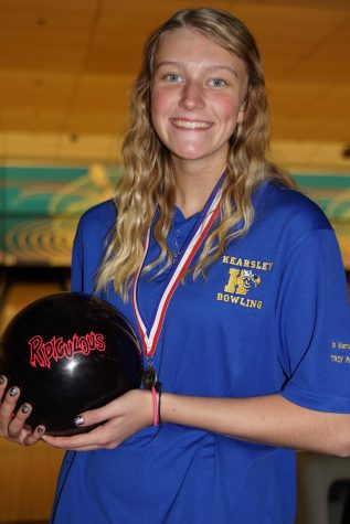 Senior Hannah Ploof holds her bowling ball after winning the 2016 individual state championship.
