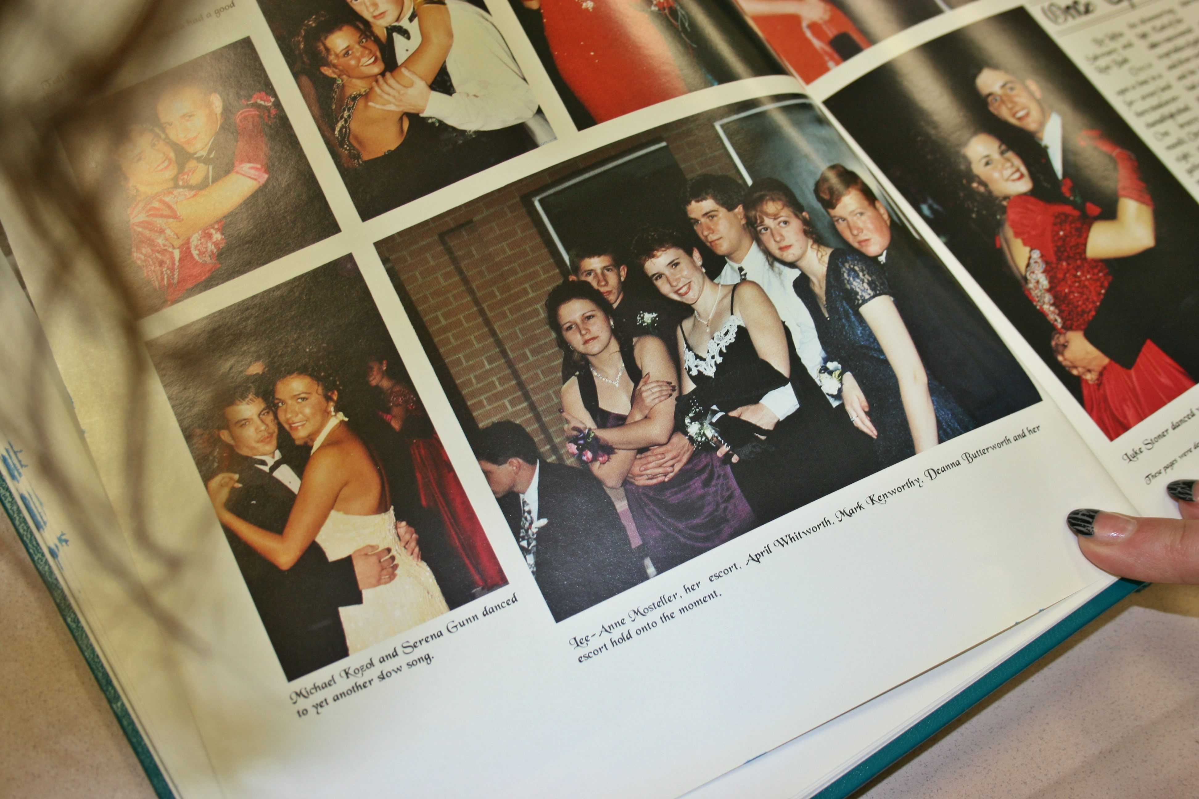 Mrs. LeeAnne Walters, a Kearsley graduate, looks at a prom photo of her friends and her in the 1996 yearbook, Echo.