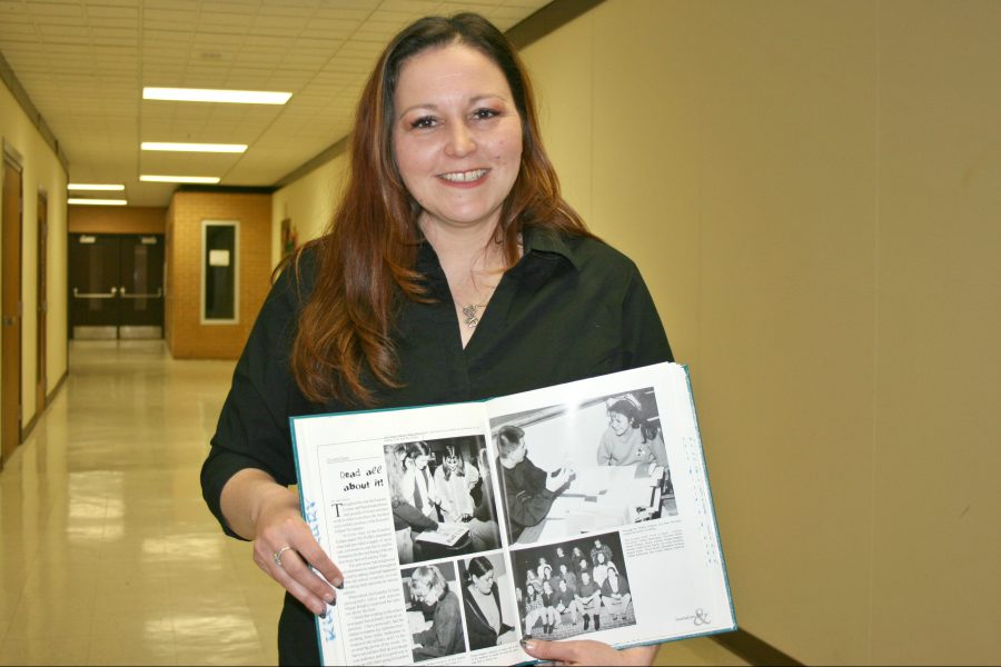 Mrs. LeeAnne Walters, a Kearsley alumna, holds her 1996 yearbook showing a picture of herself when she was an editor for The Eclipse.