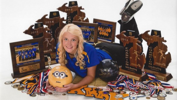 Senior Hannah Ploof poses with all of her bowling awards for a senior picture.
