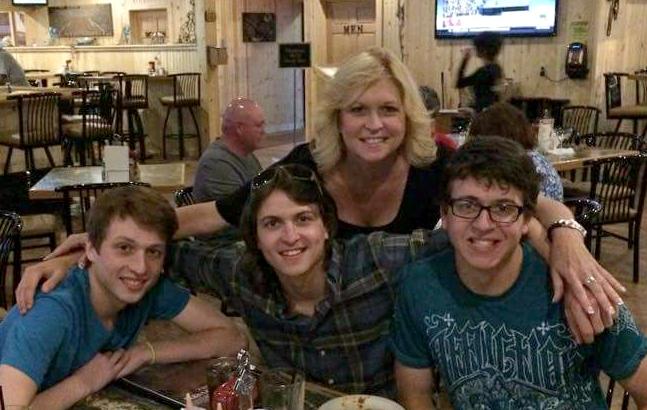 Junior Nick Niles (left) eating at a resturant eith his brothers, Mr. Stephan (left) and Chris Niles and their mother, Ms. DeAnna Robinson. 