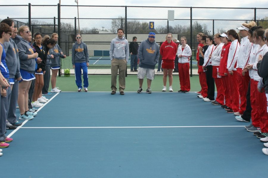The tennis team prepares to shake hands before a match against Swartz Creek earlier this season.