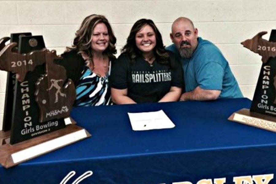 Senior Alexxa Flood (center) signs her Letter of Intent to bowl at Lincoln Memorial University with her parents. 