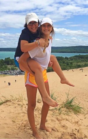 Junior Kaitlyn Alburtus (top) and sophomore Kennedy Lints wear white hats on the beach