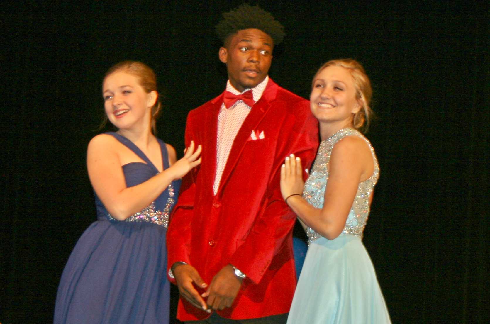 Senior Brieanna Boven (left) escorts ? during formal wear competition with ?