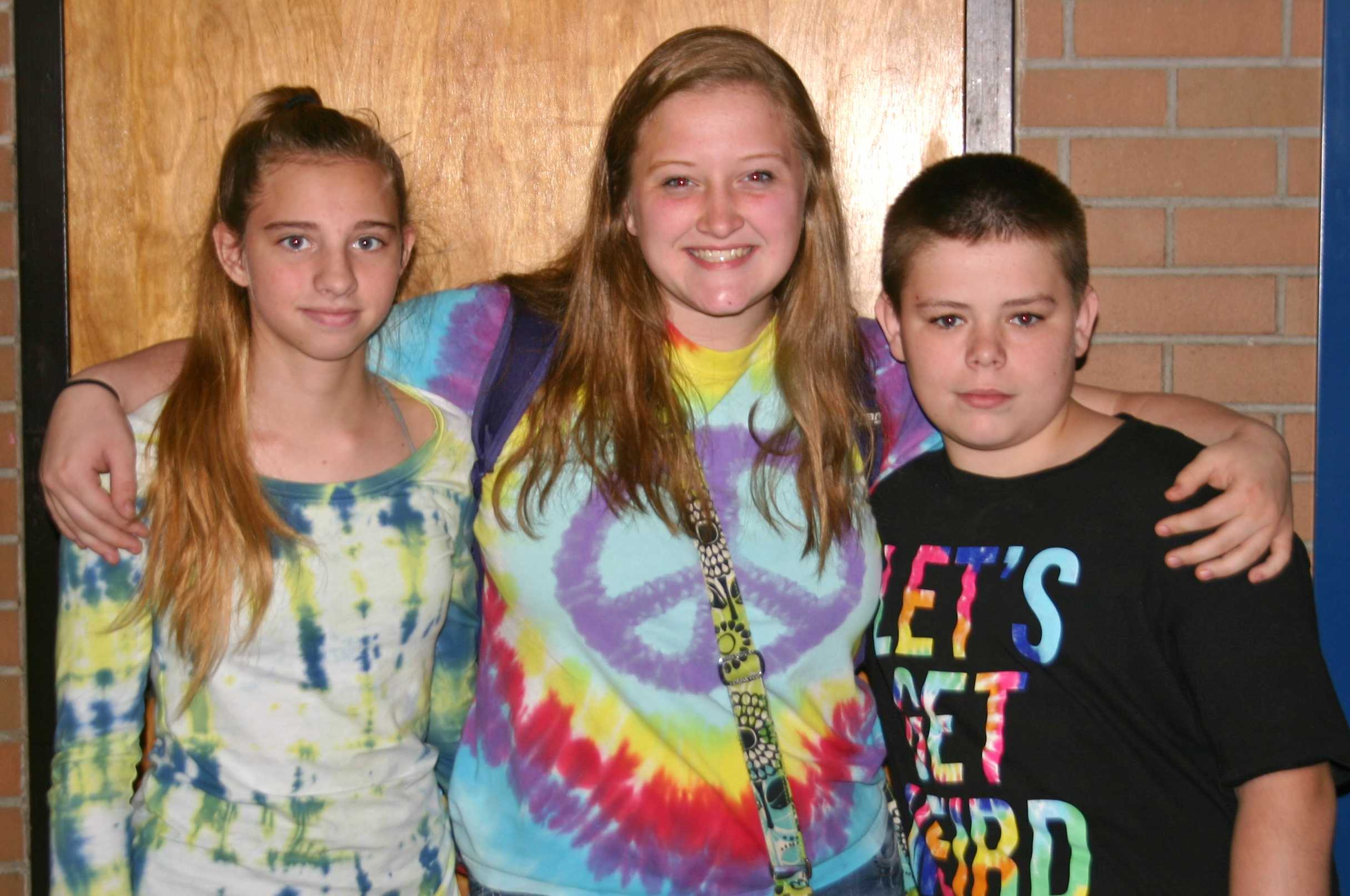 Freshman Molly Taber (l to r), sophomore Mary Wheeler, and freshman Ryan Lamb dress up for tie-dye Tuesday.