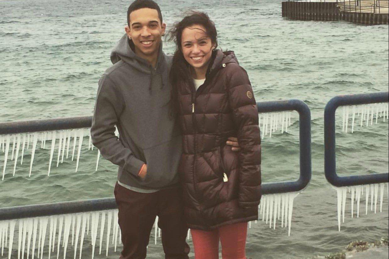 Junior Lia Silvas and alumnus Jalen Gallery try to stay warm by Lake Michigan while Silvas wears her long coat.