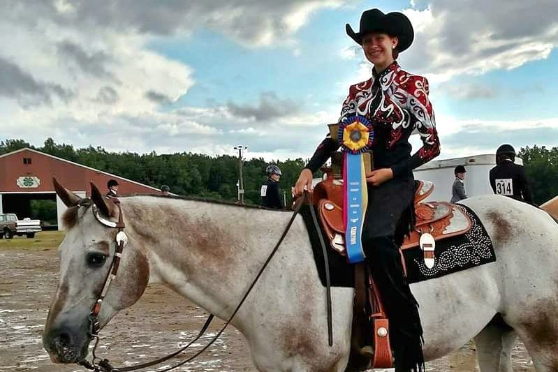 Sophomore Leah Williams shows off her ribbons atop her horse Steve at the Grand Championships in July 2016 at Genesees Cummings Center. 