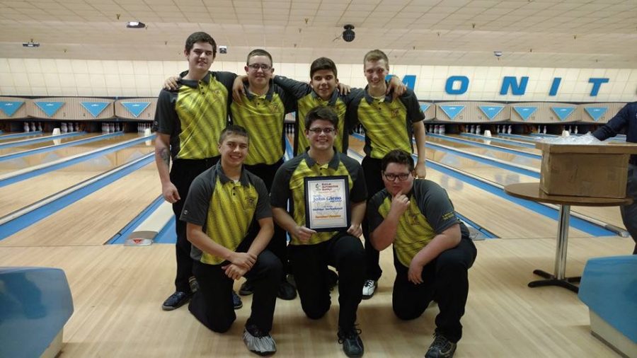 The boys bowling team shows off their first-place plaque after winning a Baker tournament in Bay City on Saturday, Dec. 17