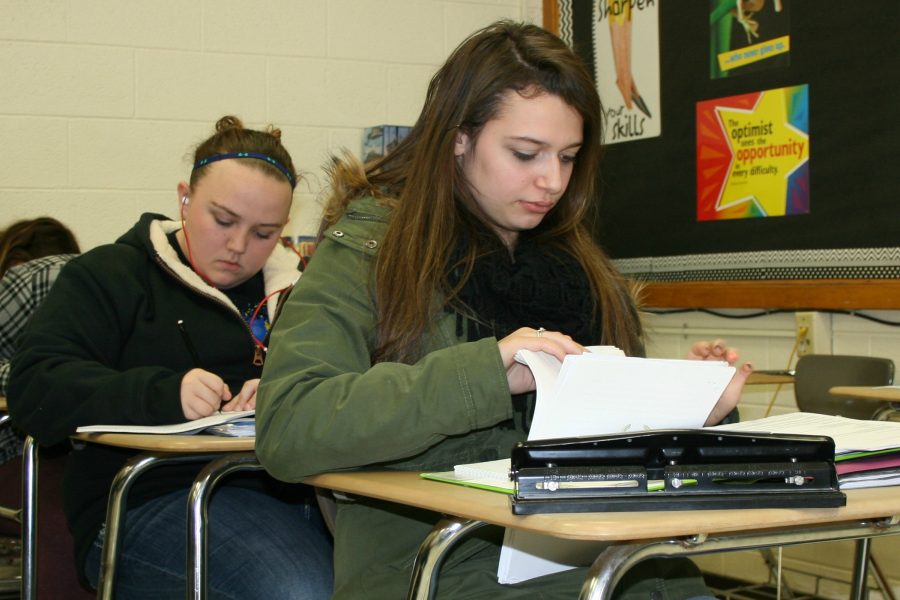 Seniors Rayanne Churchill (front) and Katelyn Bleau work in creative writing class. Churchill lives in Flint and still has lead-tainted water in her home.