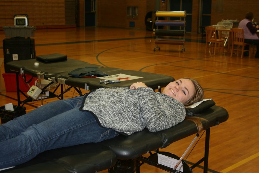 Senior Katelyn Dunn waits to have her blood drawn at  the Red Cross blood drive at Kearsley High School on Friday, Dec. 9.