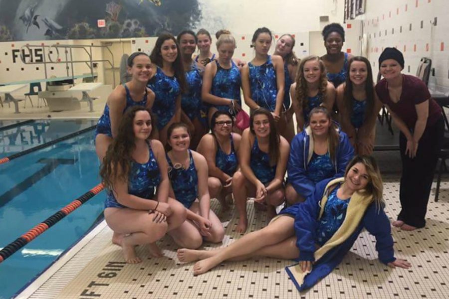 The+2016+girls+swim+team+gathers+for+a+photo+before+a+meet.+Delong+is+standing+on+the+far+right.