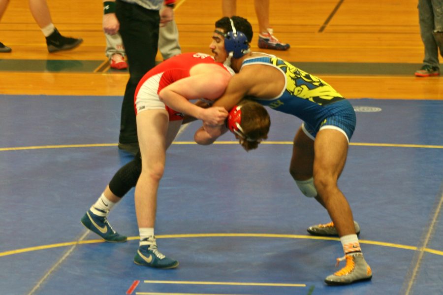 Junior Malik Davis contains his opponent in a front headlock. Davis won his match against Swartz Creek, as well as against Fenton on Wednesday, Jan. 18.