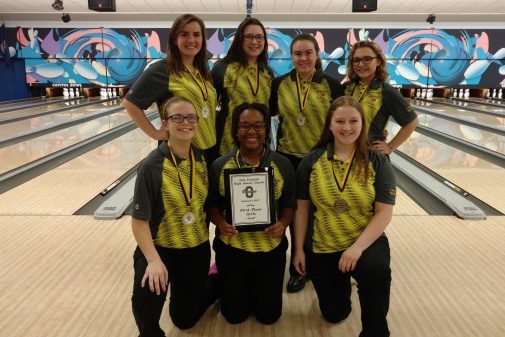 The girls bowling team shows off its championship plaque from the Lila Furnish Classic, a Baker tournament, on Sunday, Jan. 6, in Owosso.
