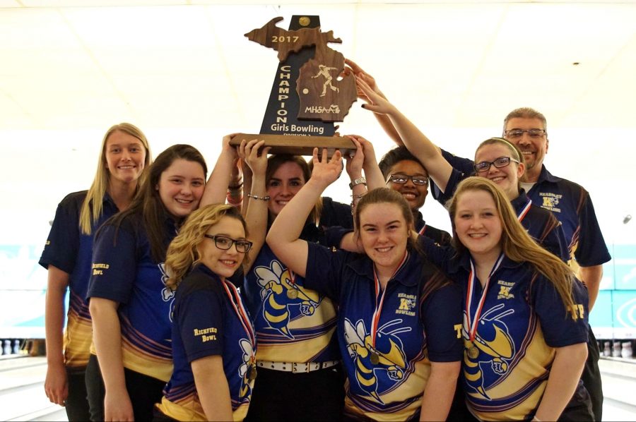 The girls bowling team hoists its trophy after winning the MHSAA Div. 2 state final in Canton on Friday, March 3. 