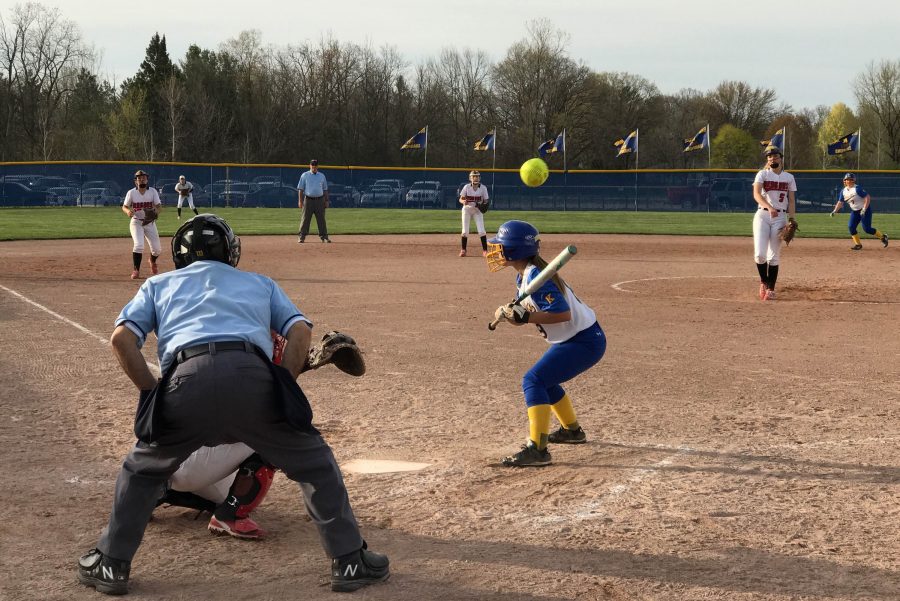 Senior Brittney Dick  ducks to avoid having her head collide with the pitch in a game against Swartz Creek on Monday, April 24.
