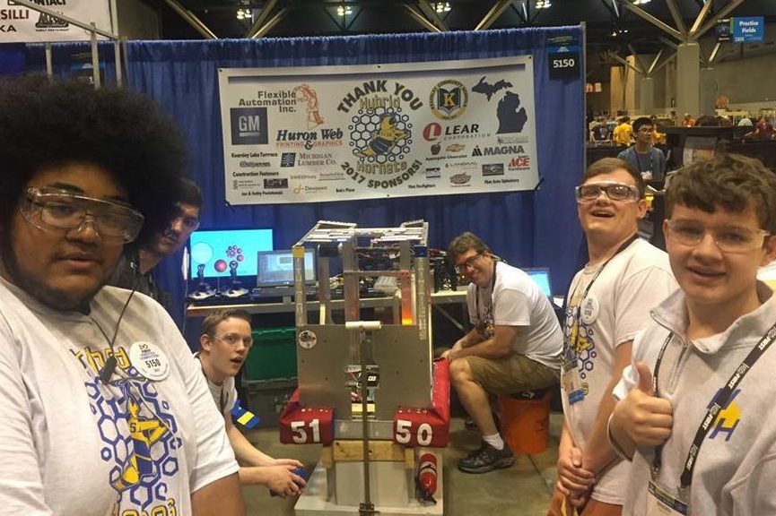 Members of the Hyrbid Hornets robotics team worked on their robot in St. Louis during the world robotics competition.