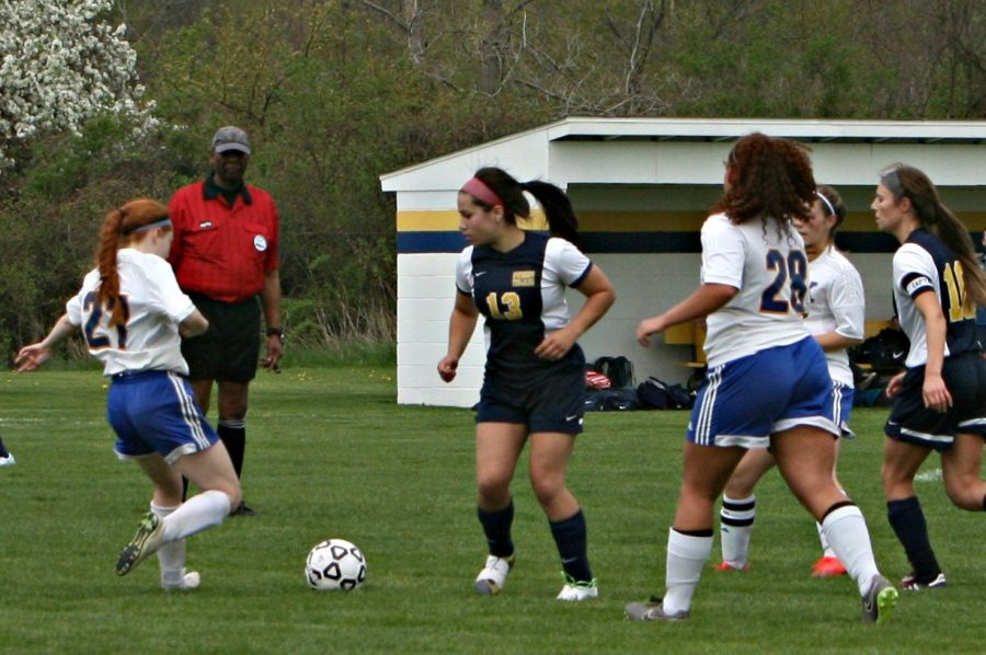 Sophomore Amber Hardy (left) fights for the ball aginst an Owosso opponent during the K-O Clash on Friday, April 28, at Kearsley.