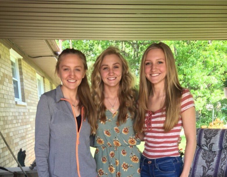 Juniors Hannah, (l to r) Kaitlyn, and Amanda VanOoteghem stop for a sisterl...