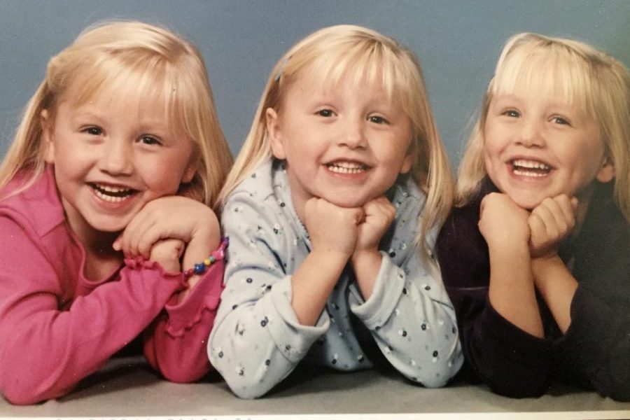 Juniors Kaitlyn, (l to r) Hannah, and Amanda VanOoteghem are triplets who share everything in their lives. In this photo, they were, obviously, young children.