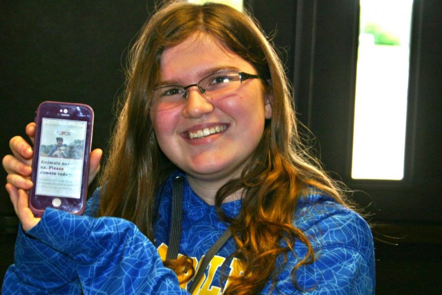 Freshman Laura Kendrick showcases the ASPCA website on her iPhone.