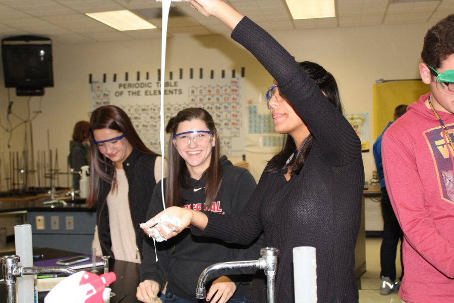 Juniors Emma Bishoff (l to r), Mickeely Dias, and Lindsay Flynn enjoy making slime for Halloween. The students made the slime during chemistry class on Monday, Oct. 30.