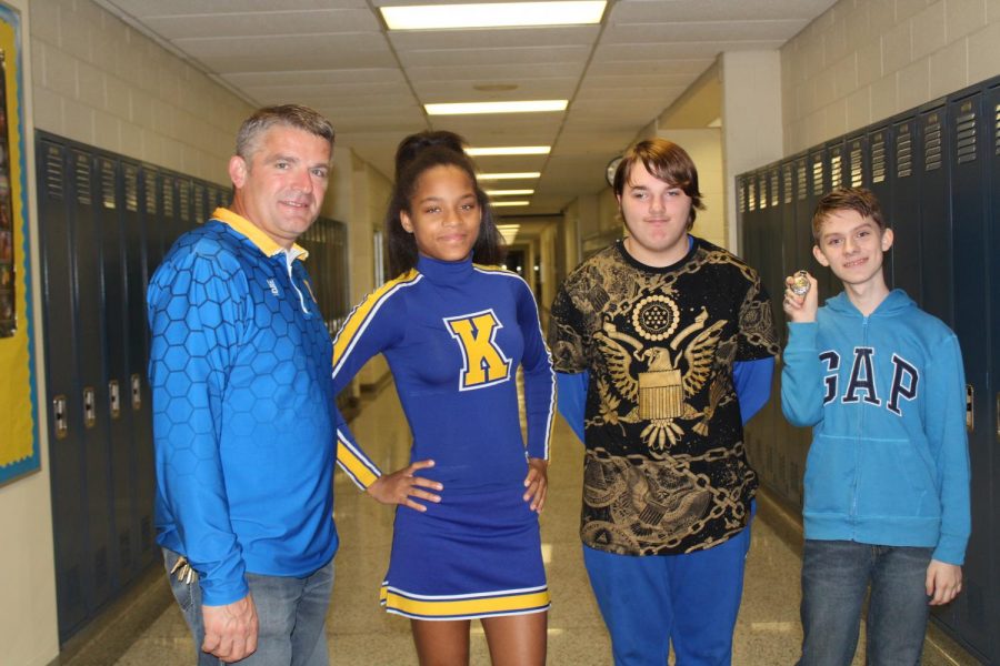 Mr. Michael Simms and his students show off their blue and gold