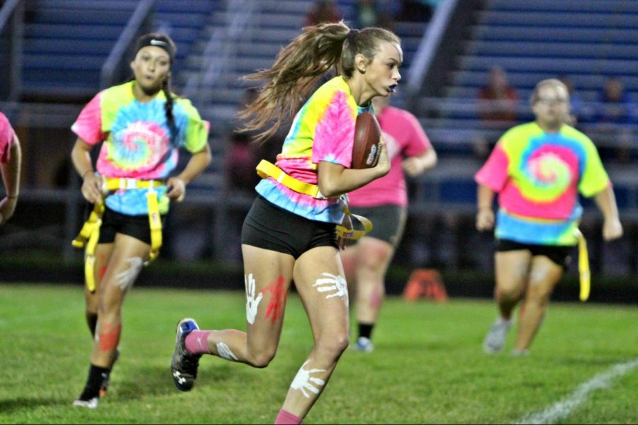 Senior Katie Lewis runs down the field to score a touchdown during the powder puff game on Monday, Oct. 9.