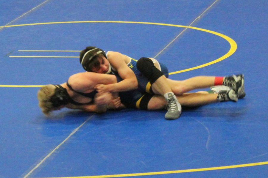 Freshman Jason Judd (top) grapples his opponent in a match against Goodrich on Wednesday, Dec. 6, at Kearsley. Judd won the match in overtime.