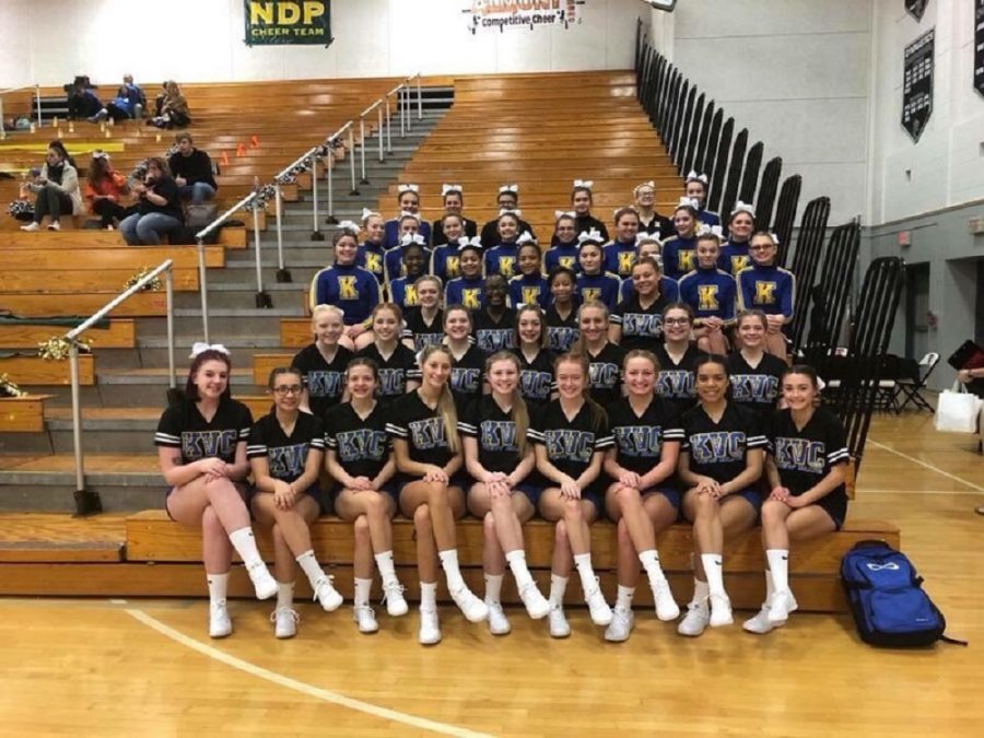 The varsity and junior varsity cheer teams pose for a picture at Troy High School before competing on Saturday, Dec. 9.  
