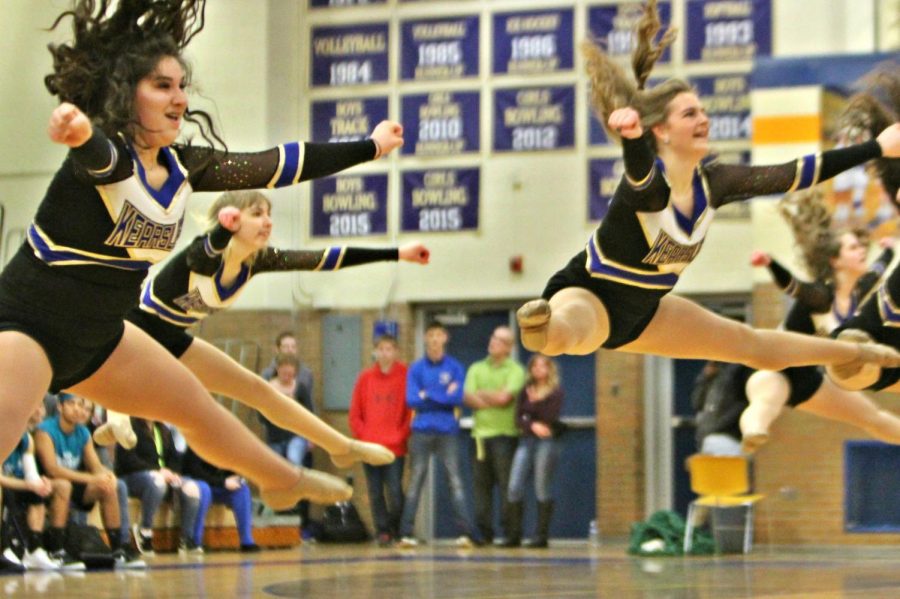 Freshman Elayna Kash (left) and junior Mallory Simms reach for the sky on their toe touch during the powdertuff event, Friday, Feb. 23.
