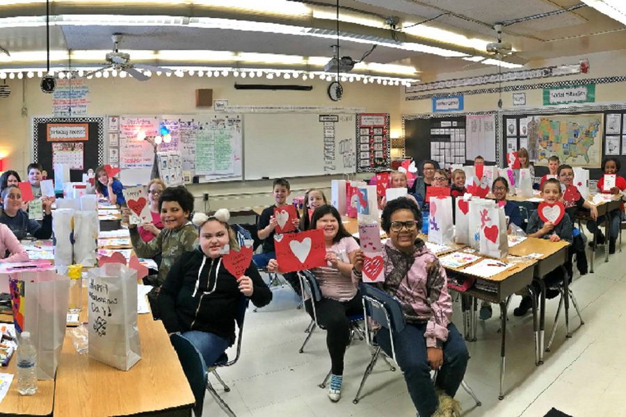 Mrs. Rae Puffers fourth-grade class holds up the Valentines Day cards they received from Mrs. Diane Hunts psychology, sociology, and math students at KHS.