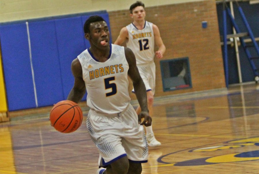 Senior Taveon Harris dribbles the ball up the court in a game against Linden on Tuesday, Feb. 6, at home.