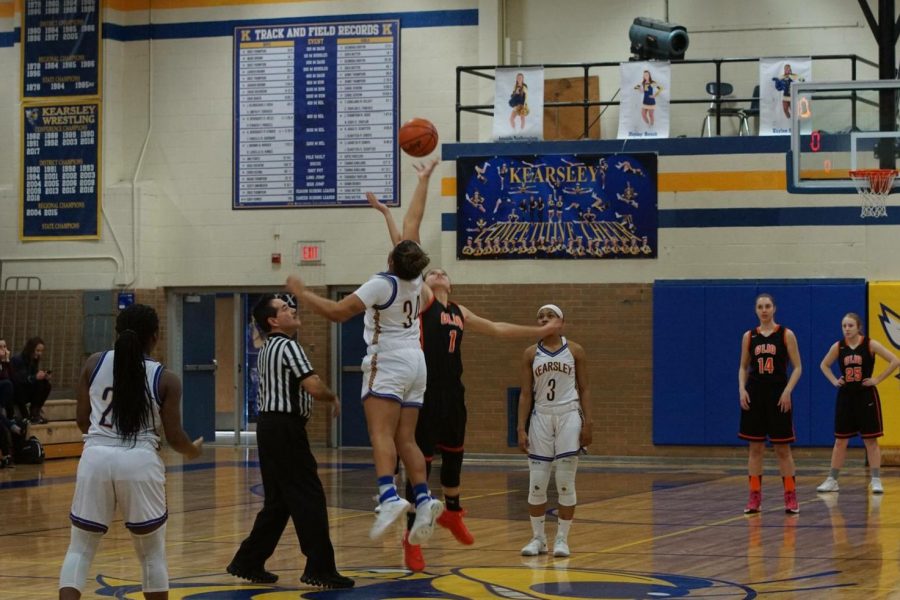 Junior Mackenzie Ramey jumps during the opening tip of a district game against Clio on Monday, Feb. 26. 