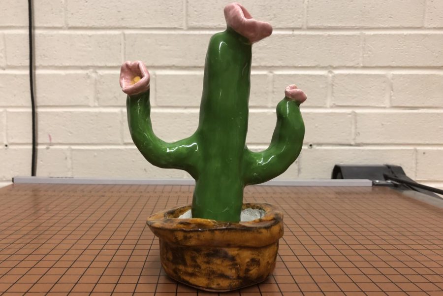 Junior Mickeely Dias formed a small cactus with clay in her studio art class. Dias decided on a cactus to fit her flower theme.