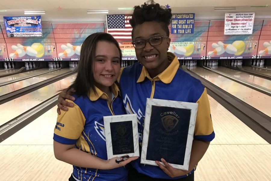 Senior Karlee Griffin (left), and sophomore Imari Blond celebrate with their plaques from the Carman-Ainsworth Singles Tournament on Sunday, Feb. 4. Blond won the tournament and Griffin finished third.