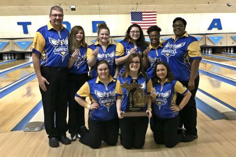 The girls bowling team shows off its championship trophy after its MHSAA Division 2 regional Friday, Feb. 23 in Bay City.