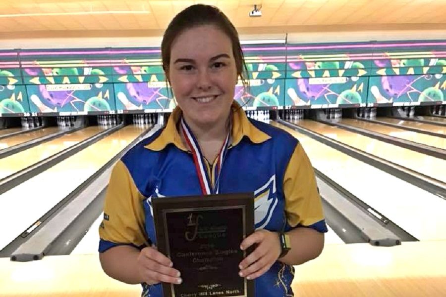 Senior Emma Boychuk shows off her Metro League singles champion award after winning the leagues singles tournament Saturday, Feb. 16.